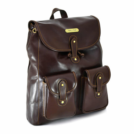 Style n Craft 392151 Backpack in Full Grain Dark Brown Leather, Medium Size - Front Angled View Showing Top Flap Closure & 2 Front Pockets & Leather Hand Carry Strap