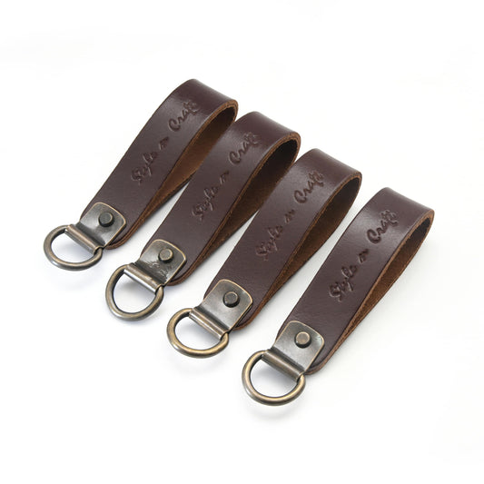 Style n Craft 98200 - Leather D-Ring Loop Set (4 Pcs) for Suspender Attachment in Dark Tan Color - Front Angled View. Each Set Contains 4 Leather Loops attached to the D-ring with a metal plate